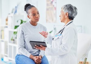 Female doctor speaking to female patient about bariatric surgery.